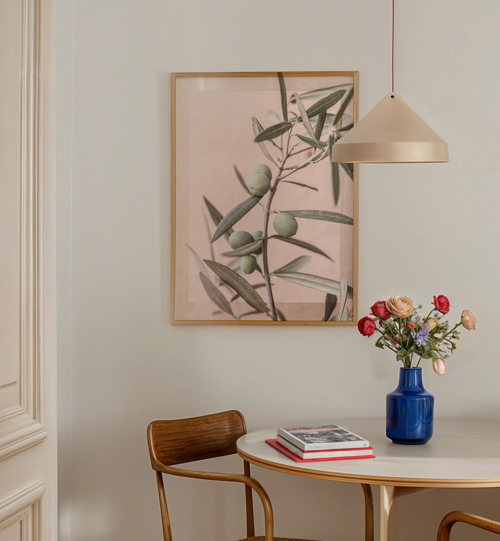 Elegant OLIVES, FLORAL FLOWER PAINTINGS adorn a cozy dining space, enhancing the atmosphere with natural beauty.