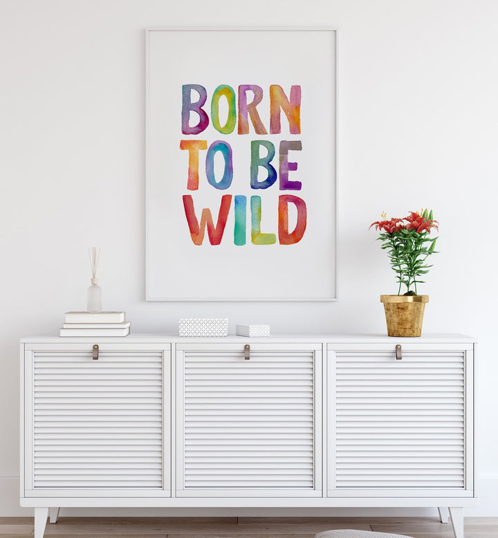 Colorful "BORN TO BE WILD, QUOTES" typography poster by Brett Wilson, perfect for inspiring adventure in any space.