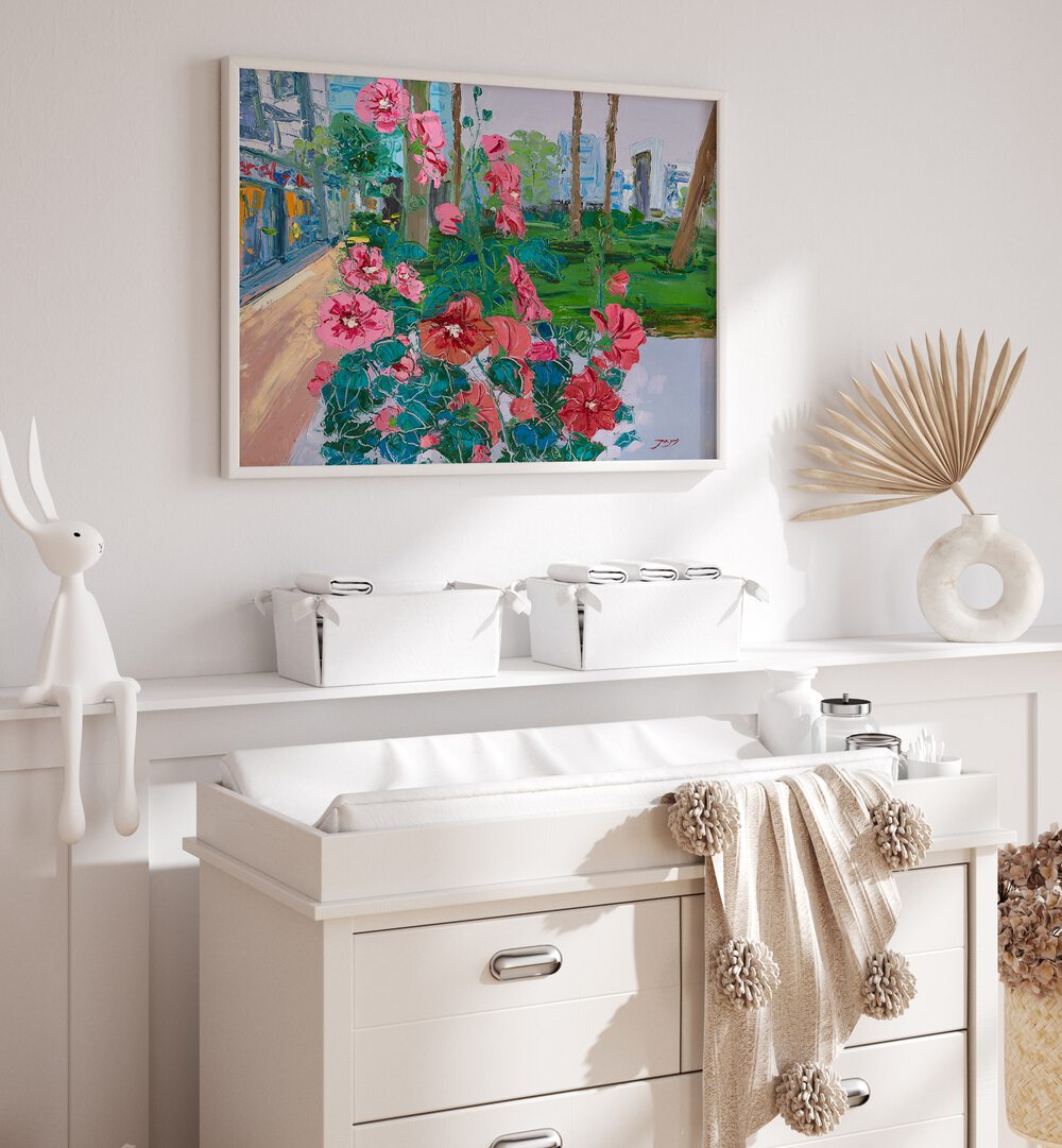 VIBRANT PINK FLOWERS, FLORAL FLOWER PAINTINGS adorn a stylish nursery, bringing color and warmth to the space.