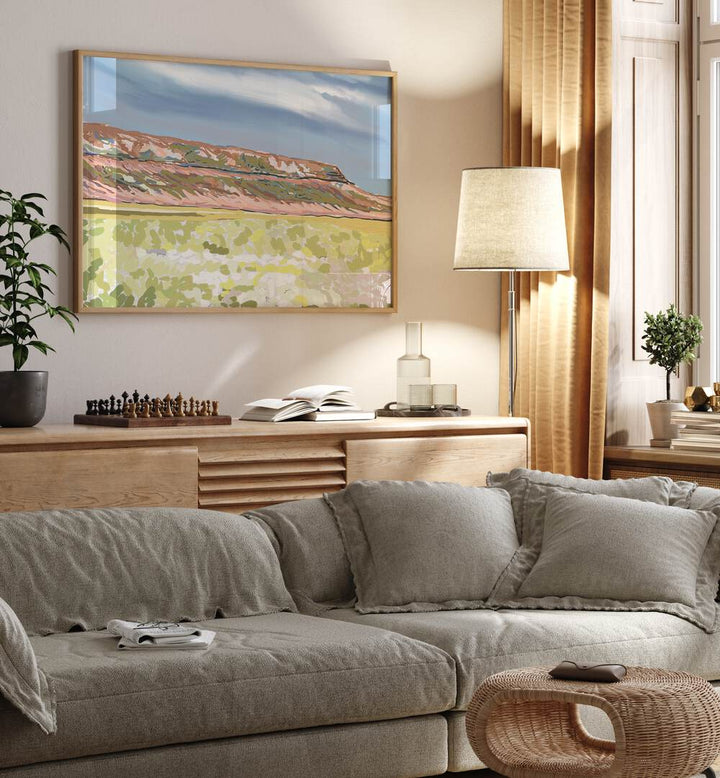 Bright and inviting living space featuring "MEMORIES IN BLOOM, LANDSCAPE PAINTINGS" art print above a cozy sofa.