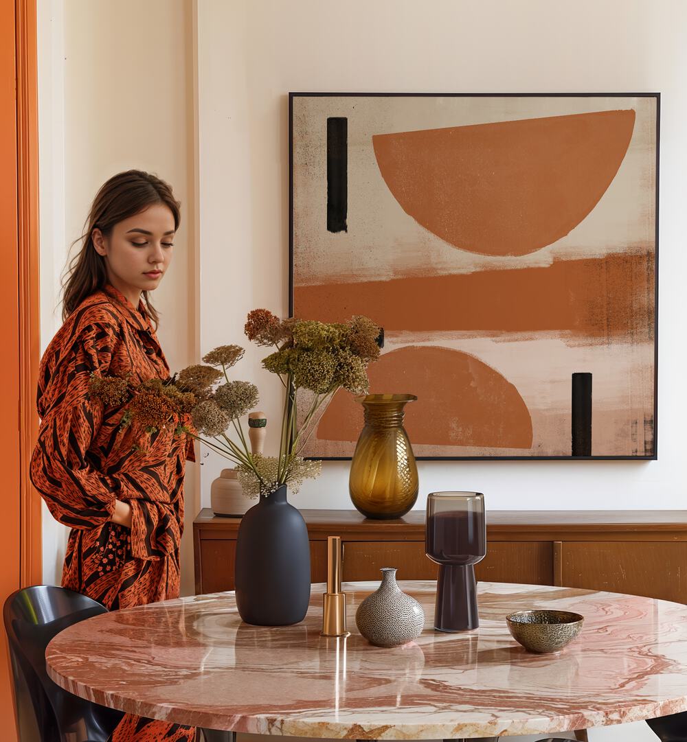 Stylish woman beside a table with flowers and decor, showcasing INTERACTION, ABSTRACT PAINTINGS for modern spaces.