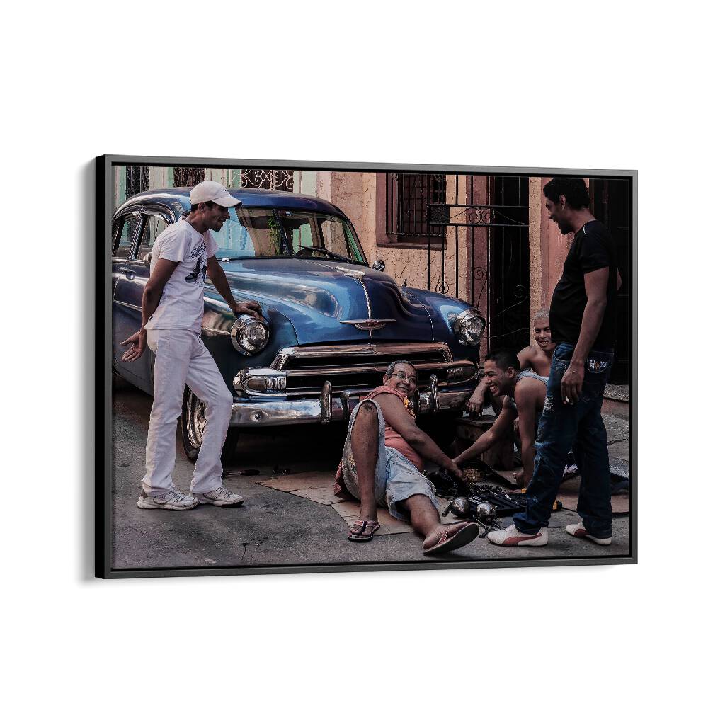 Urban scene featuring a group repairing a car, perfect for REPAIRING A CAR, PHOTOGRAPHY PRINTS collection.