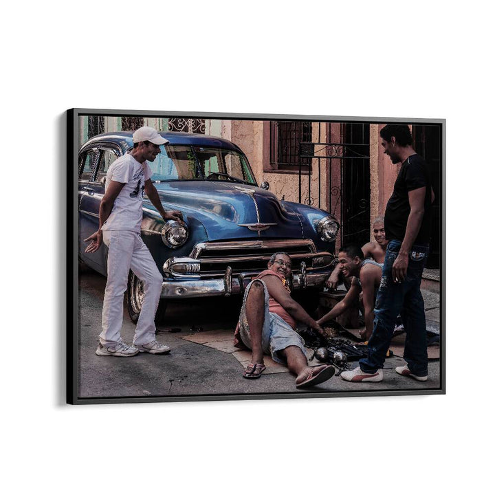 Urban scene featuring a group repairing a car, perfect for REPAIRING A CAR, PHOTOGRAPHY PRINTS collection.