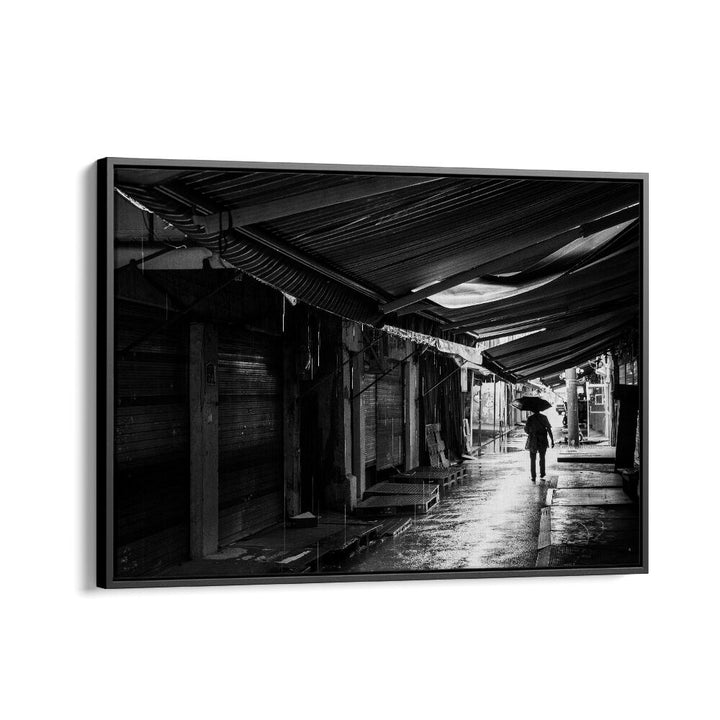 Captivating RAINY, PHOTOGRAPHY PRINTS showcase a lone figure under an umbrella in a moody, wet street scene.