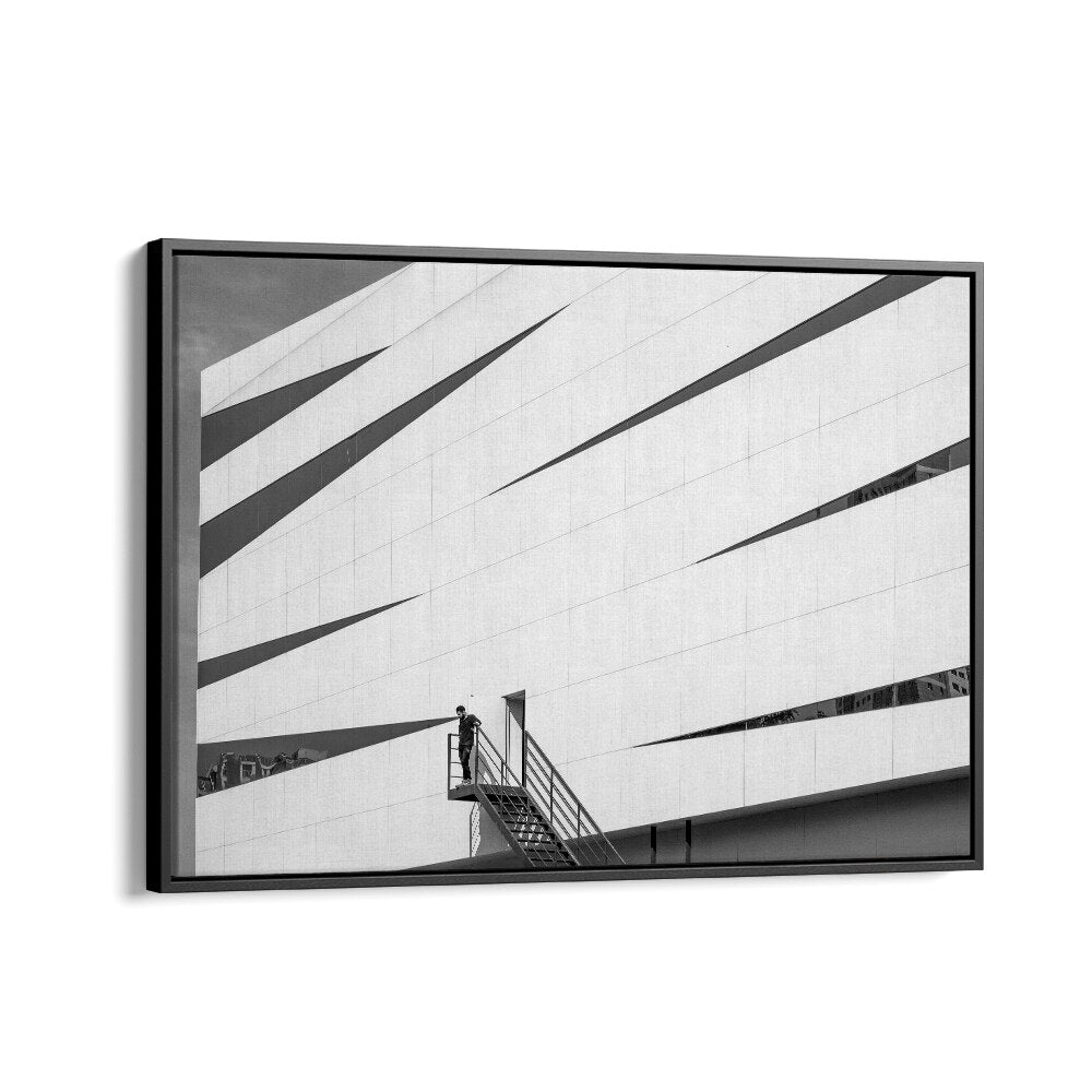 Modern architecture meets urban life in UNTITLED IX, PHOTOGRAPHY PRINTS, capturing striking moments in black and white.