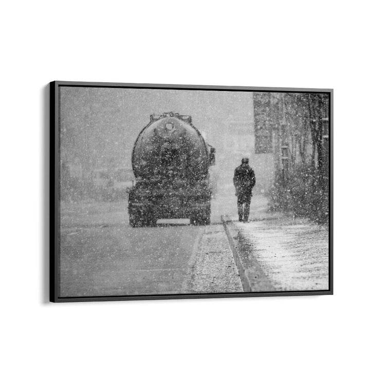 Black and white photograph of a truck in snow with a solitary figure, showcasing HEAVY THINGS, PHOTOGRAPHY PRINTS.