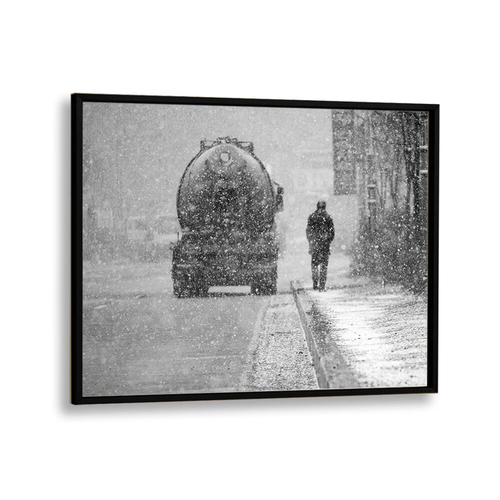 Black-framed HEAVY THINGS, PHOTOGRAPHY PRINTS capture a snowy urban scene with a figure walking amidst the storm.