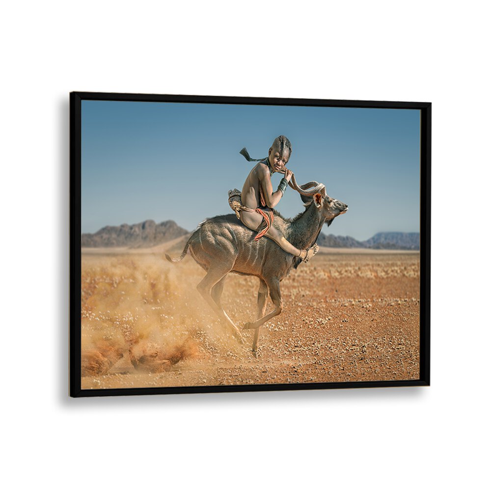 Experience the wild with EASY RIDER, PHOTOGRAPHY PRINTS showcasing a boy riding an antelope in stunning landscapes.