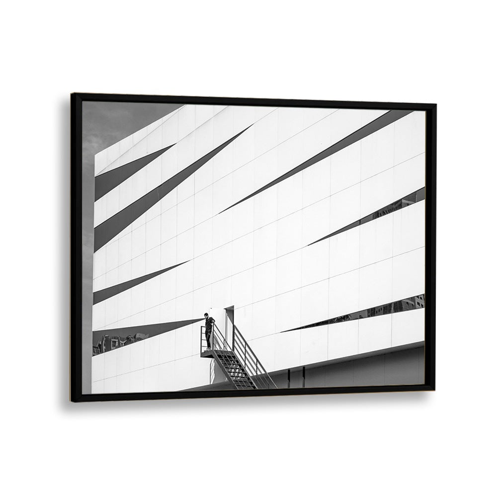 Framed UNTITLED IX, PHOTOGRAPHY PRINTS showcasing striking urban architecture and a solitary figure on a staircase.