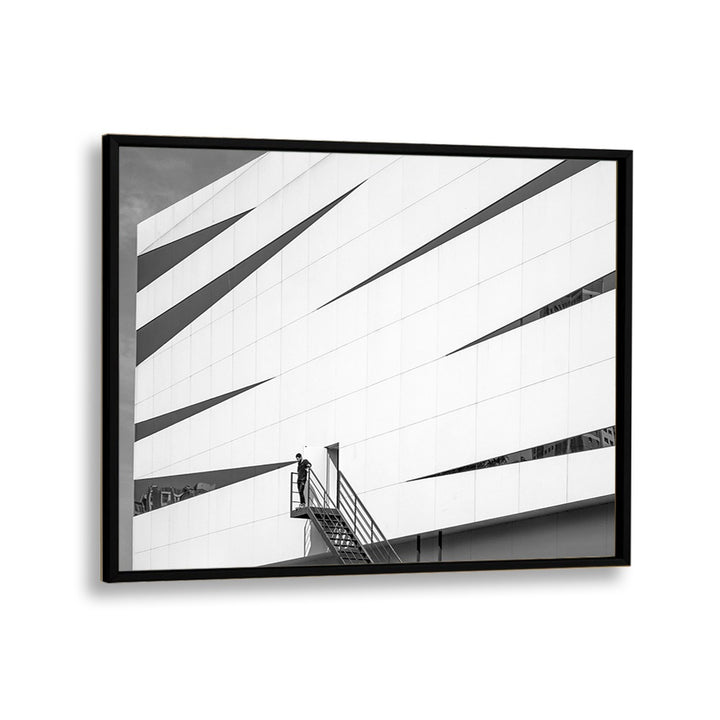 Framed UNTITLED IX, PHOTOGRAPHY PRINTS showcasing striking urban architecture and a solitary figure on a staircase.
