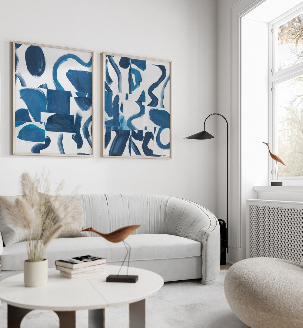 Stylish living room featuring the BLUE ABSTRACT SET, SET OF 2 PAINTINGS, showcasing elegant blue brushstrokes.