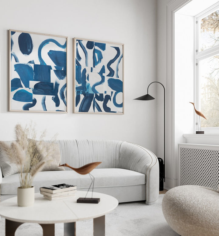 Stylish living room featuring the BLUE ABSTRACT SET, SET OF 2 PAINTINGS, showcasing elegant blue brushstrokes.