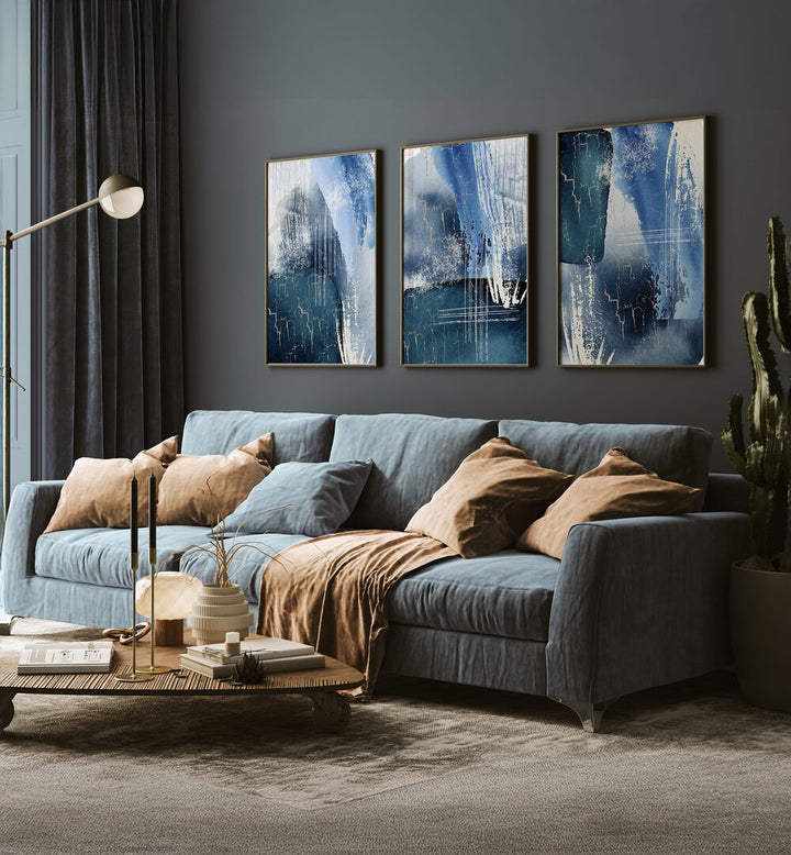Elegant BLUE LAGOON SET, SET OF 3 PAINTINGS enhancing a stylish living room with serene lagoon-inspired art.
