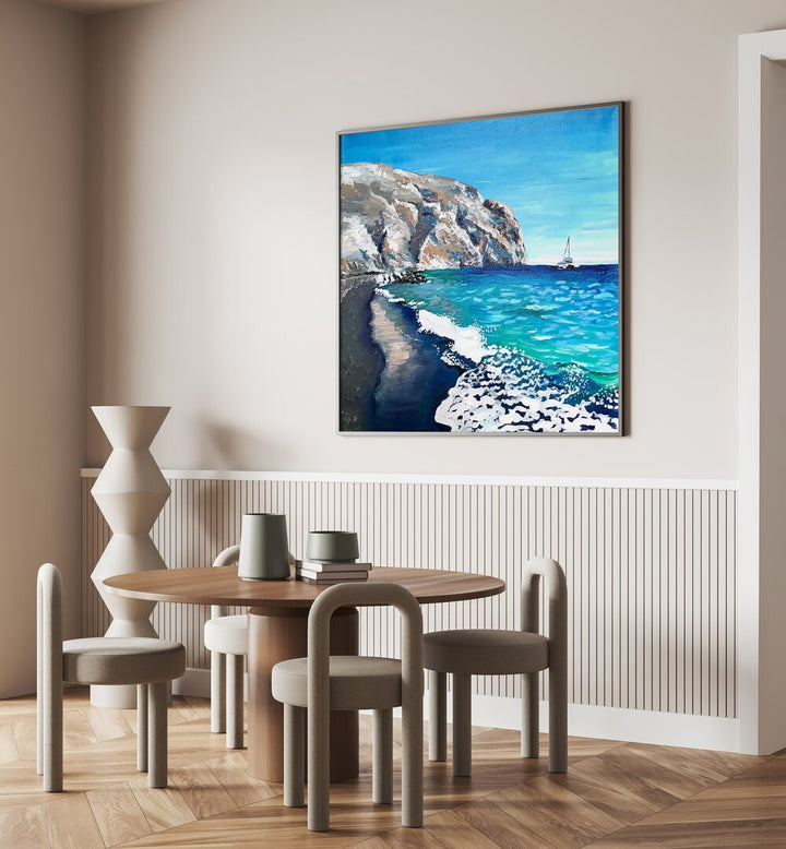Black Sand Beach By Key And Sea Creative Landscape Artwork in Black Plain Frame on a cream wall behind a dining table