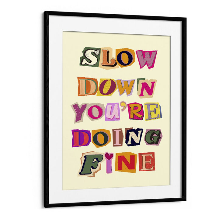 Framed artwork featuring the phrase "SLOW DOWN YOU'RE DOING FINE," perfect for any stylish space.