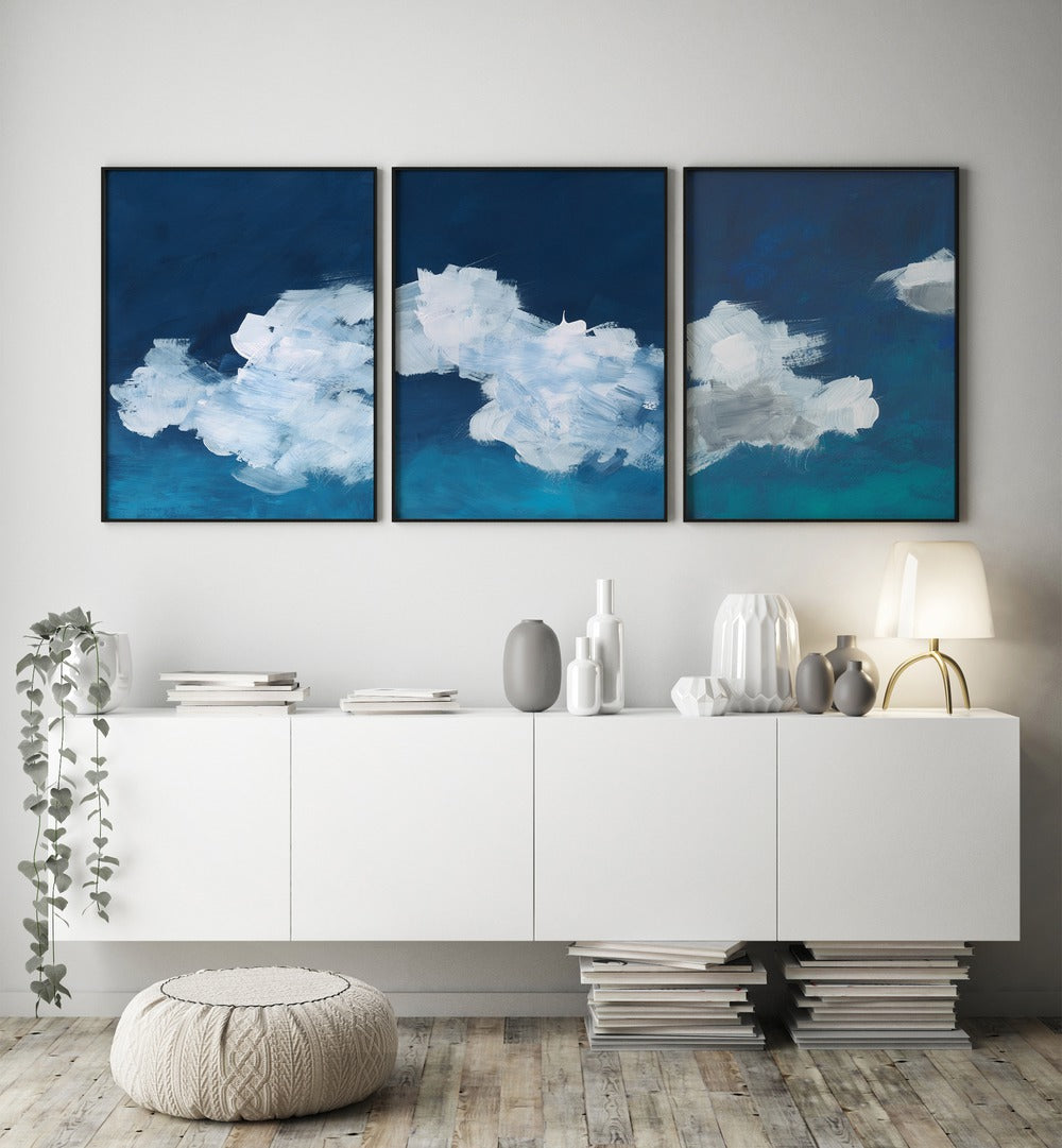 CLOUDS ABSTRACT SET, SET OF 3 PAINTINGS showcases serene blue and white cloud art, perfect for any tranquil space.