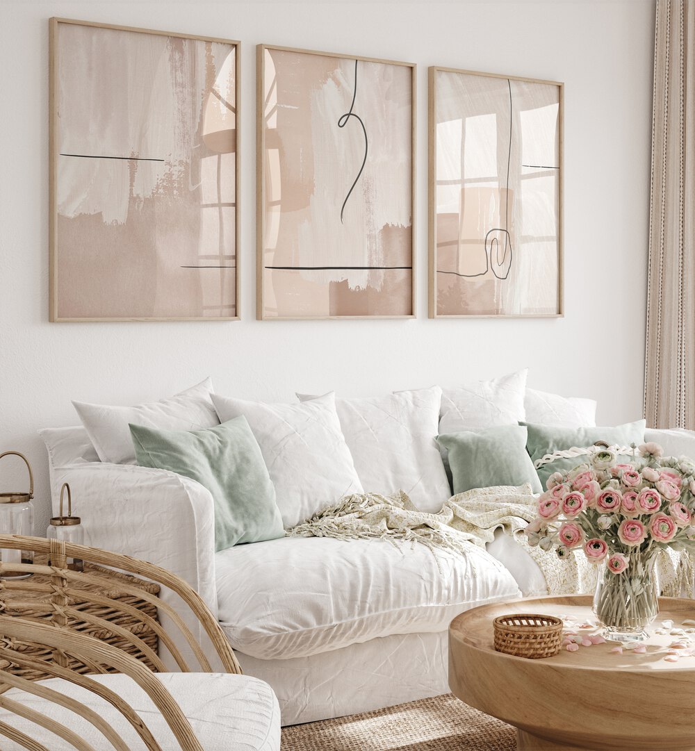 Modern living room featuring the CREAM ABSTRACTION SET, SET OF 3 PAINTINGS with elegant creamy hues and abstract designs.