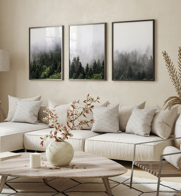 Serene living room featuring the CLOUDY MOUNTAINS, SET OF 3 PAINTINGS, showcasing misty forest landscapes.