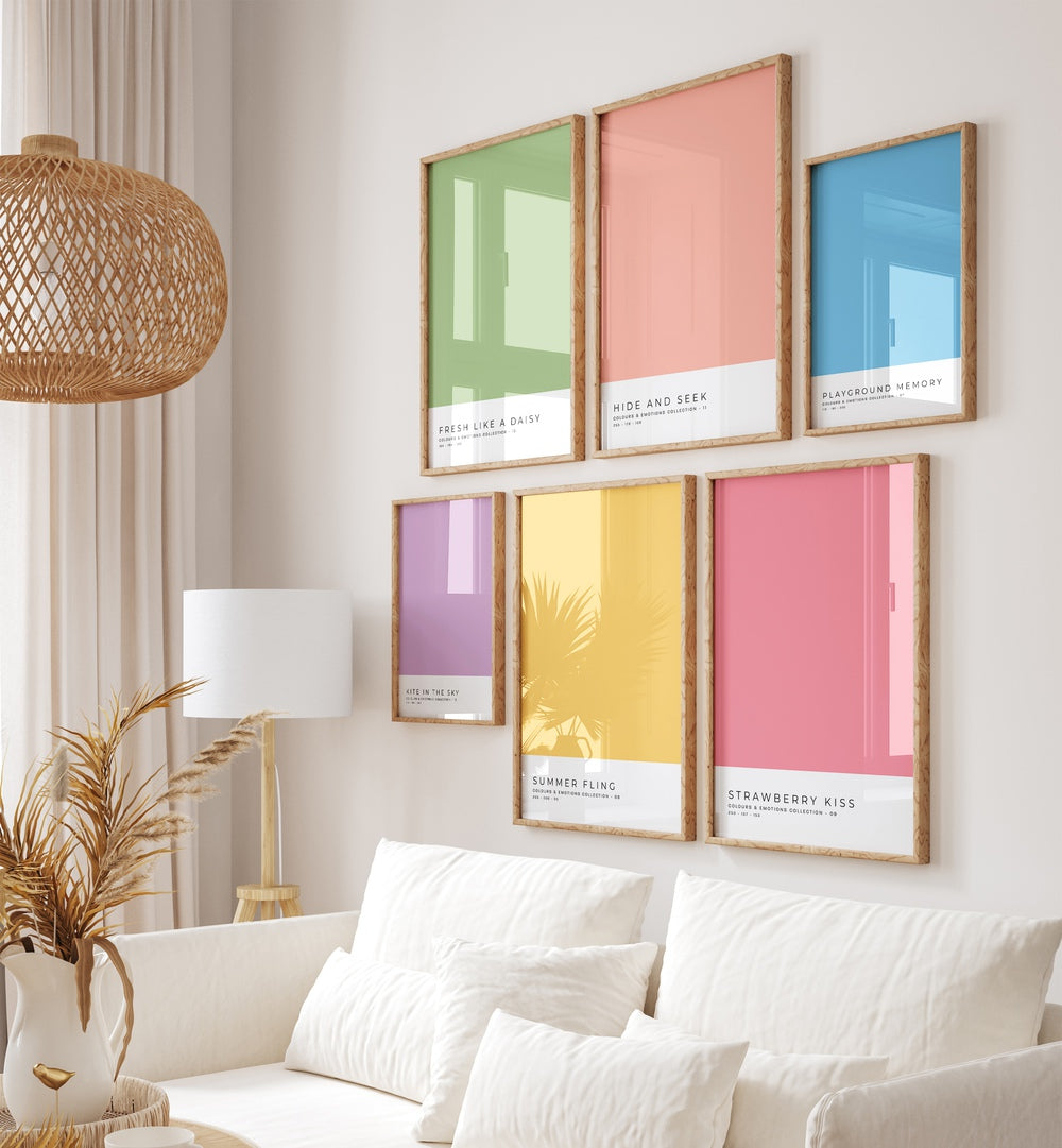 Stylish COLOR PALETTE GALLERY WALL with vibrant art above a white couch, enhancing modern gallery walls in any living room.