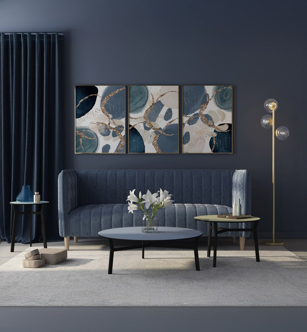 Stylish DENIM BLUE SET, SET OF 3 PAINTINGS enhancing a modern living room with rich hues and elegance.