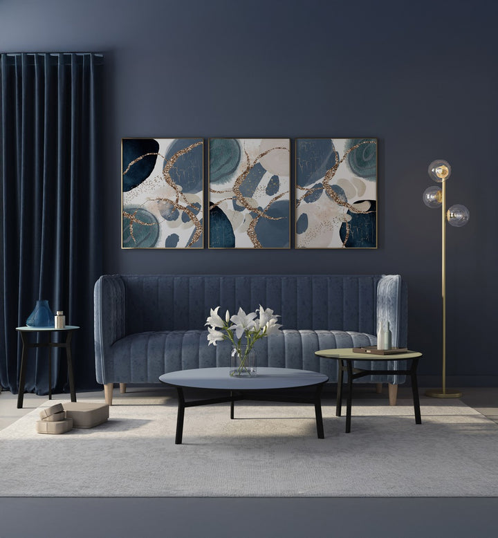 Stylish DENIM BLUE SET, SET OF 3 PAINTINGS enhancing a modern living room with rich hues and elegance.