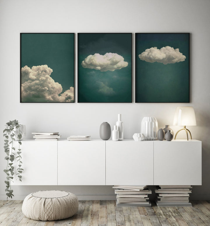 Elevate your decor with the EMERALD CLOUDS SET, SET OF 3 PAINTINGS featuring serene emerald hues and soft clouds.