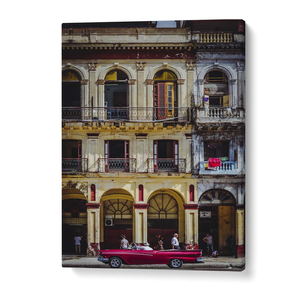 Vibrant red car parked on a bustling Habana street, capturing the essence of Cuban life in photography prints.