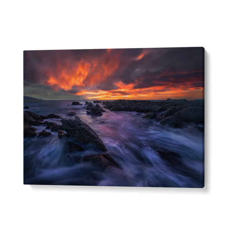 Stunning sunset over rocky coastline, perfect for decor with BURNING SKY, PHOTOGRAPHY PRINTS. Transform your space today!