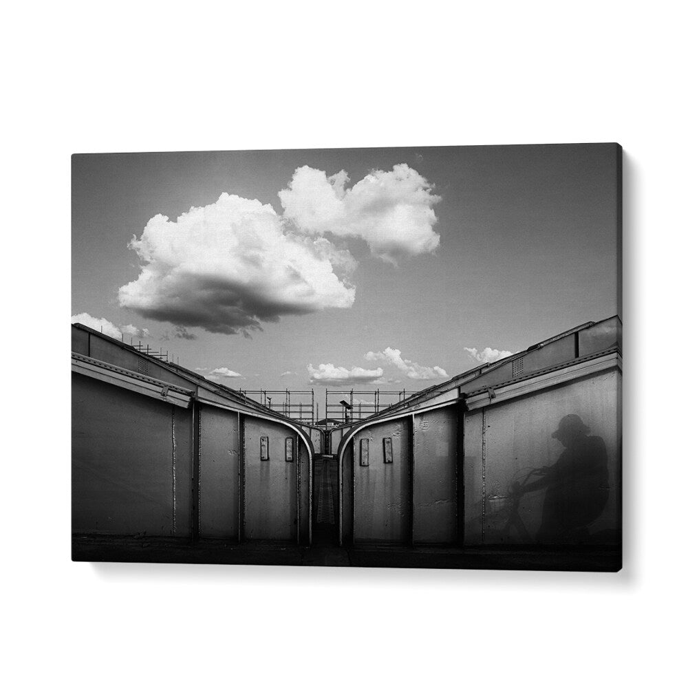"ON THE BRIDGE, PHOTOGRAPHY PRINTS capture an urban scene with dramatic clouds and shadows, showcasing city life."