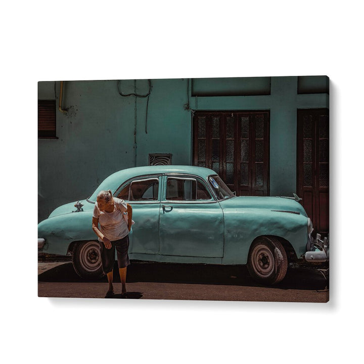 Explore urban life with PASSING STREET, PHOTOGRAPHY PRINTS, featuring a woman near an antique turquoise car.