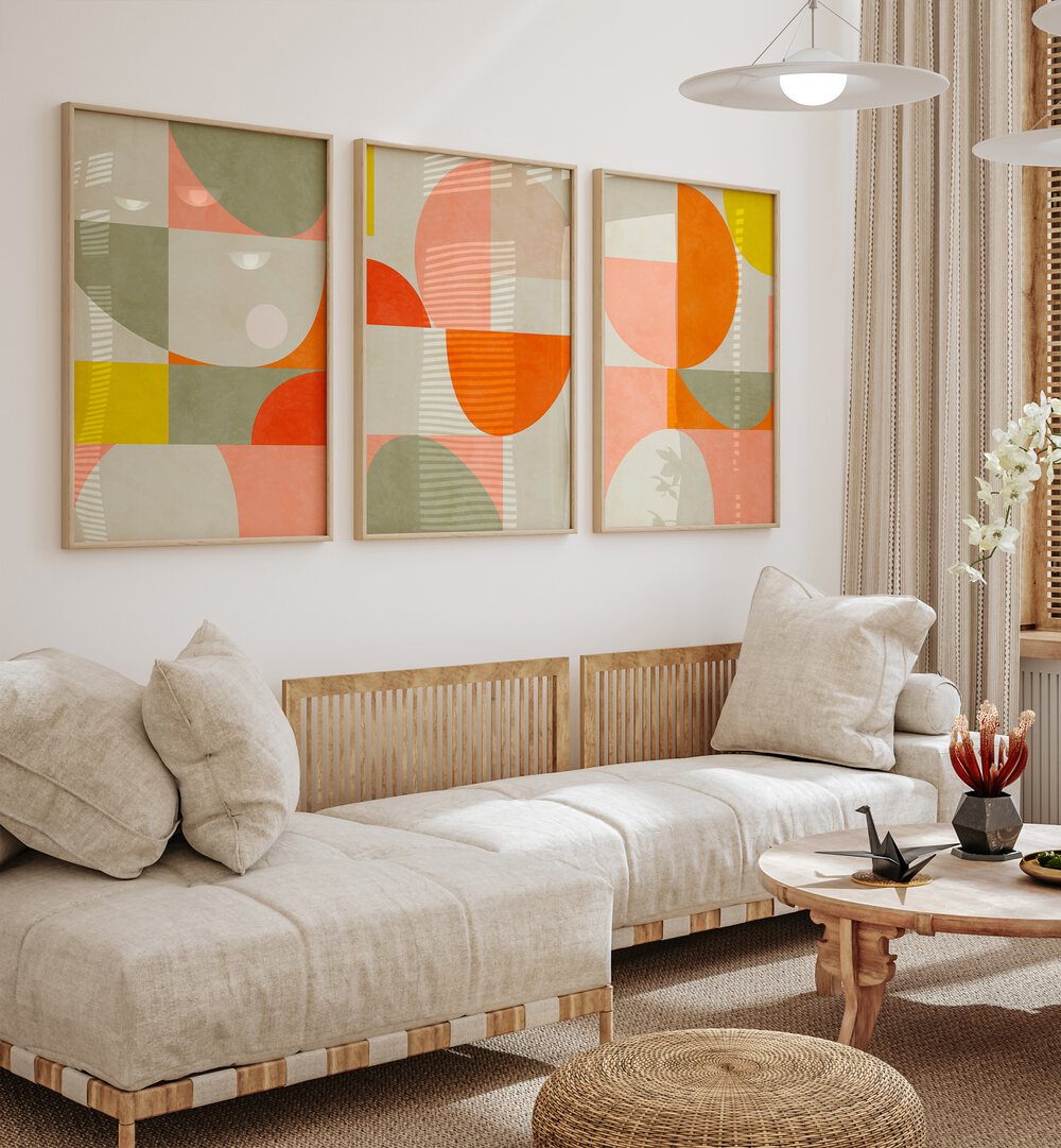 Stylish living room featuring the GEOMETRIC SUMMER ABSTRACTIONS SET, SET OF 3 PAINTINGS in vibrant colors.