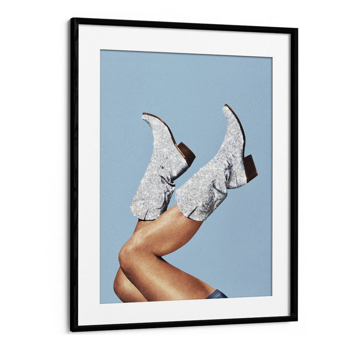 "GLITTER BOOTS BLUE II, SURREAL ART PRINTS by Vertigo Artography showcase stylish boots against a serene blue backdrop."