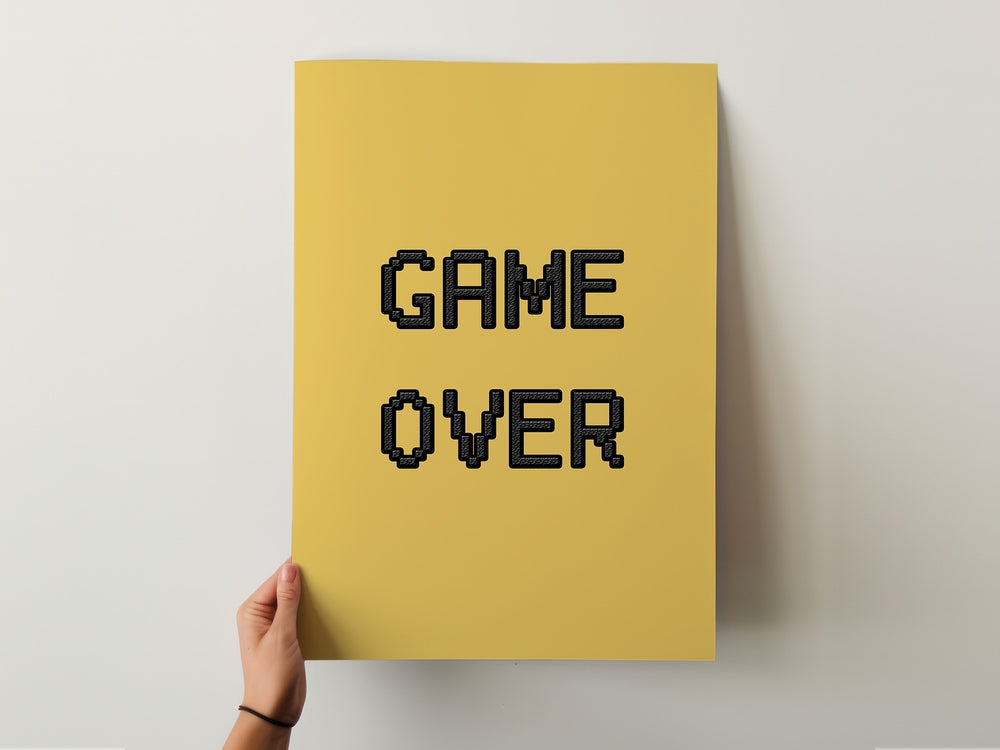 Bold "GAME OVER" poster on a yellow background, perfect for gamers' walls. Elevate your space with GAME OVER, GAMING POSTERS.
