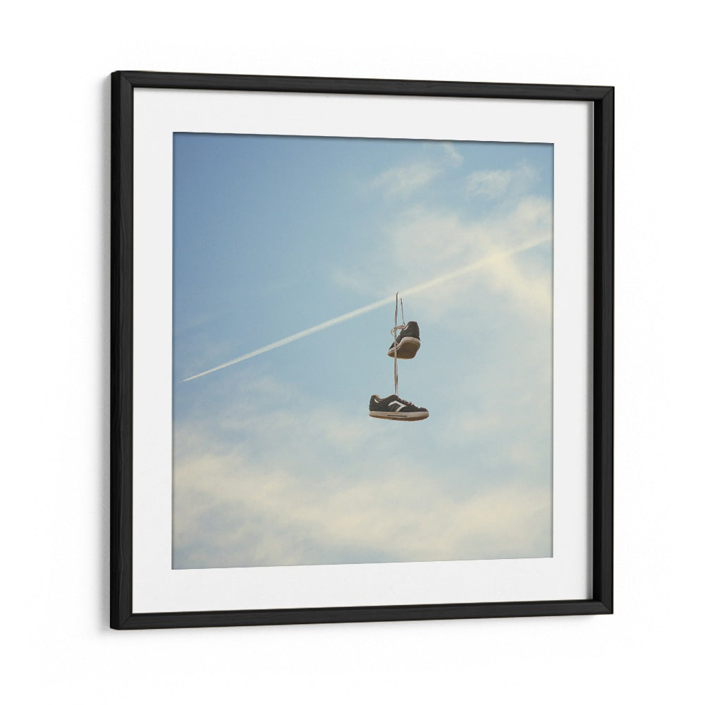 Hang N There surreal painting by Vertigo Artography features sneakers suspended against a serene sky, embodying surreal art.