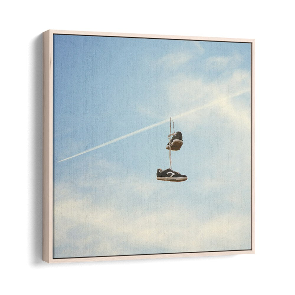 "HANG N THERE SURREAL PAINTING, SURREAL ART featuring shoes suspended against a serene blue sky by Vertigo Artography."