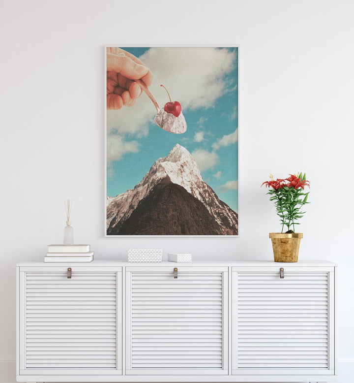 Hand holding a cherry-topped dessert above a mountain, showcasing ICE CREAM SUNDAE SUMMIT, SURREAL ART PRINTS by Vertigo Artography.