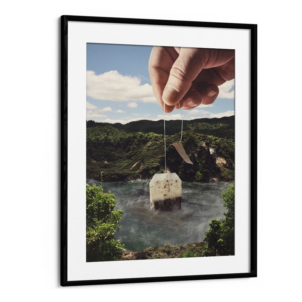 Hand placing a teabag into a serene lake scene in "LAKE AFTERNOON TEA, SURREAL ART PRINTS" by Vertigo Artography.