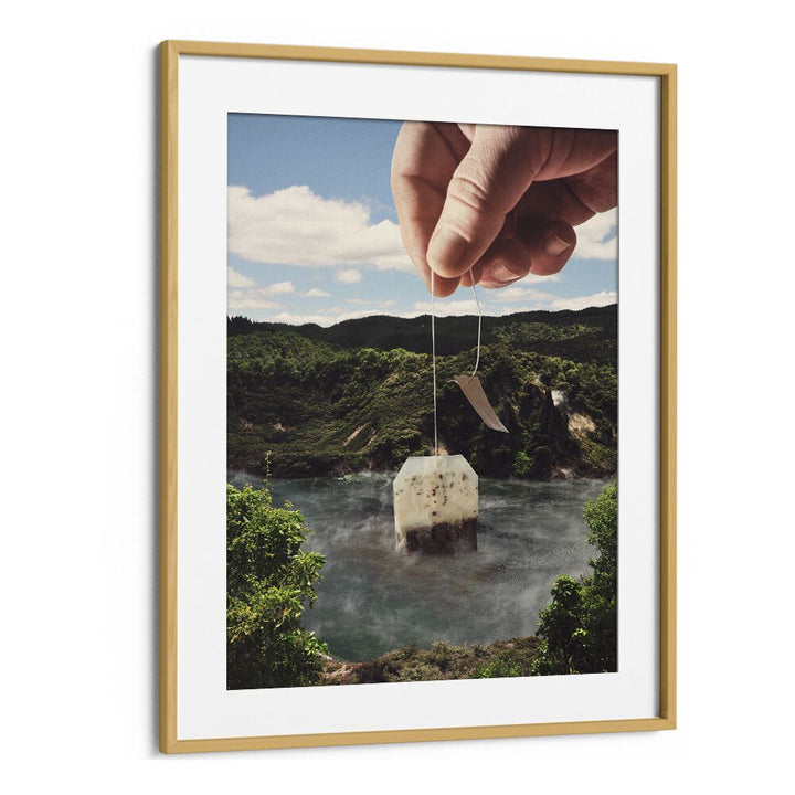 Hand holding a teabag over a serene lake, capturing the essence of LAKE AFTERNOON TEA, SURREAL ART PRINTS by Vertigo Artography.