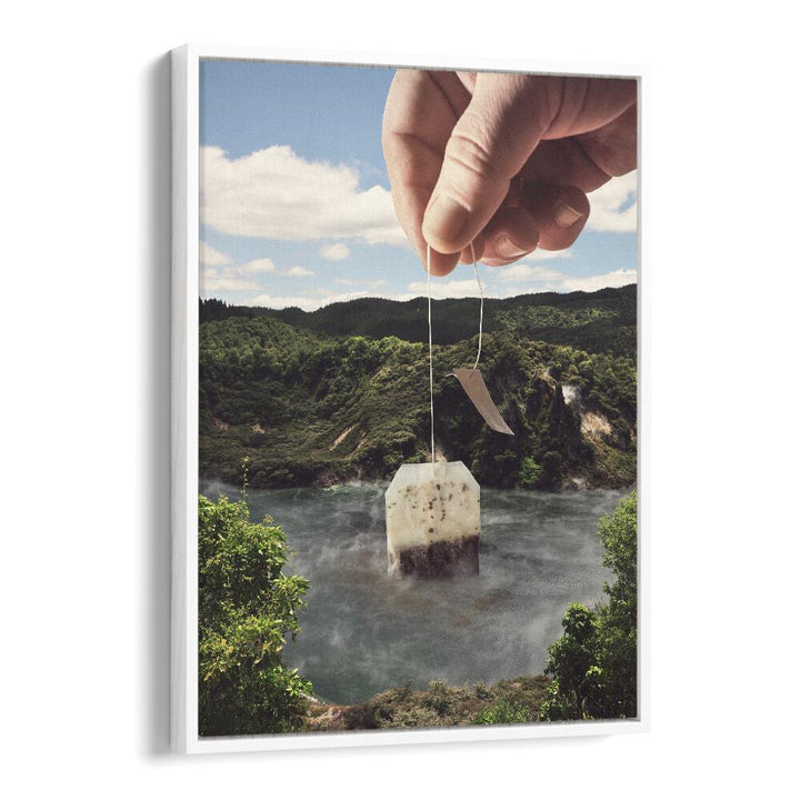 Hand holding a teabag above a serene lake landscape, showcasing LAKE AFTERNOON TEA, SURREAL ART PRINTS by Vertigo Artography.