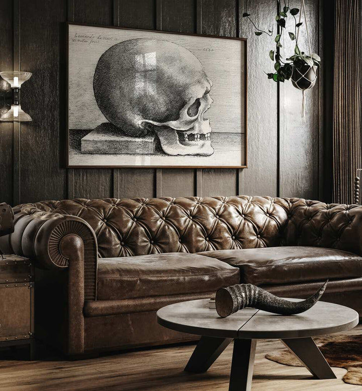 Leonardo Da Vincis Skull In Profile To Right 1645 Vintage Paintings in Dark Oakwood Plain Frame placed on a wall behind a brown sofa