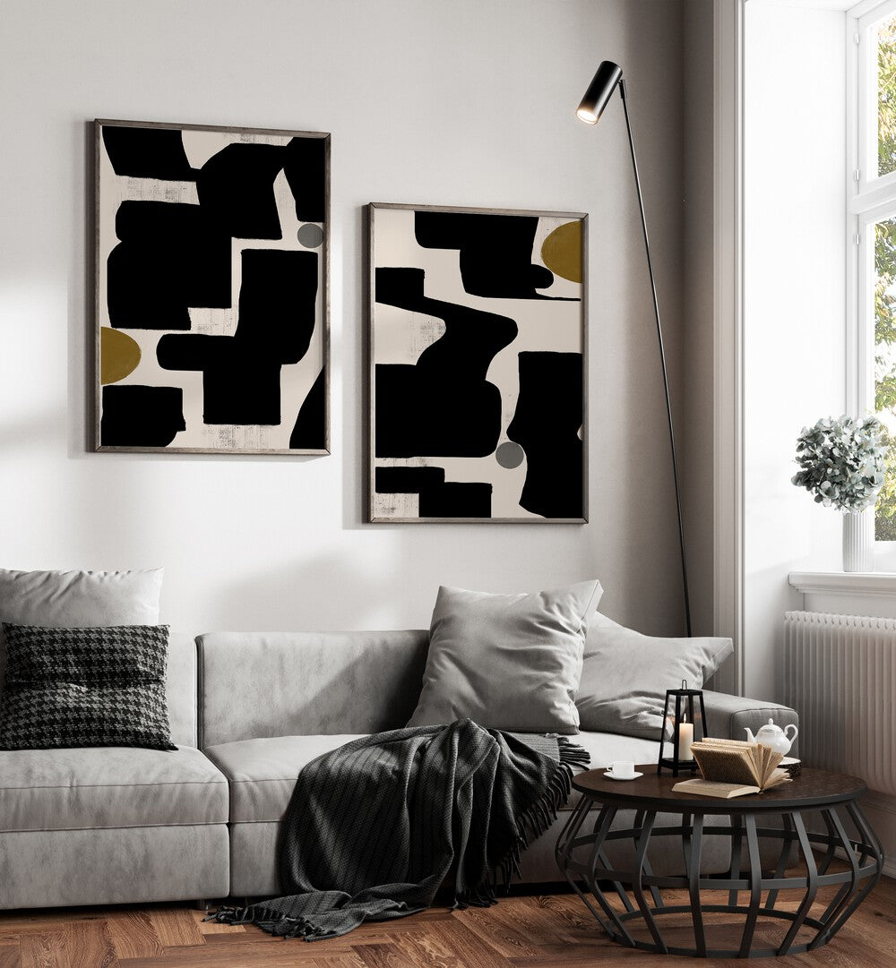 Stylish MONOCHROME RHYTHM SET, SET OF 2 PAINTINGS enhancing a modern living room with bold black, white, and gold designs.