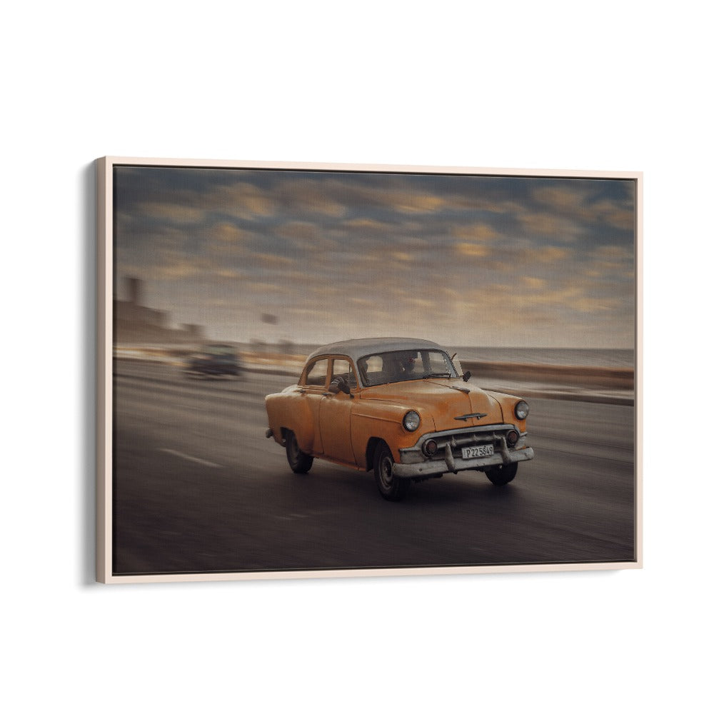 Capture the essence of street life with MALECON VII, PHOTOGRAPHY PRINTS featuring a vintage yellow car in motion.