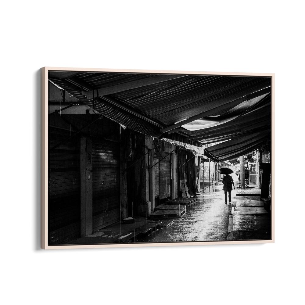 Captivating RAINY, PHOTOGRAPHY PRINTS showcase a lone figure with an umbrella amidst a serene, empty street scene.