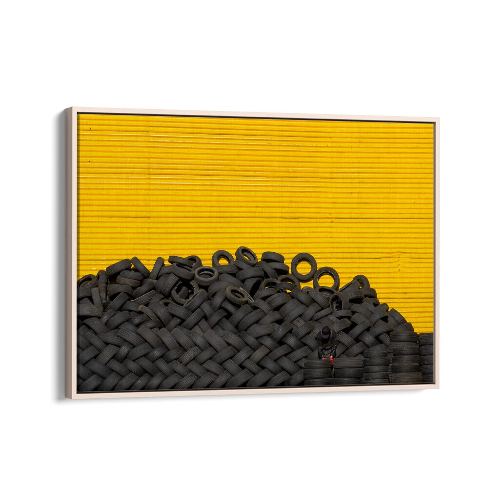 Artistic arrangement of tires against a vibrant yellow background for unique TIRES, PHOTOGRAPHY PRINTS. Perfect for urban themes.