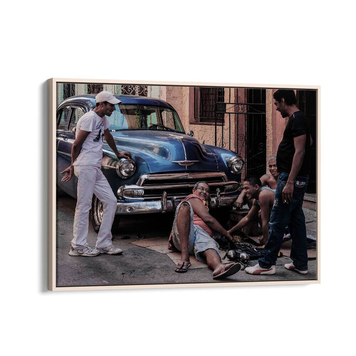 Repairing a car in the streets, showcasing urban artistry with our REPAIRING A CAR, PHOTOGRAPHY PRINTS collection.
