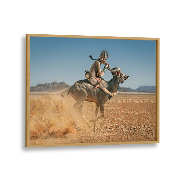 Experience the adventure of wildlife with EASY RIDER, PHOTOGRAPHY PRINTS showcasing a child riding a kudu.