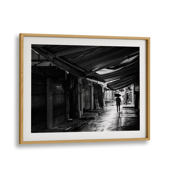 Captivating RAINY , PHOTOGRAPHY PRINTS showcasing a lone figure with an umbrella on a wet, serene street.