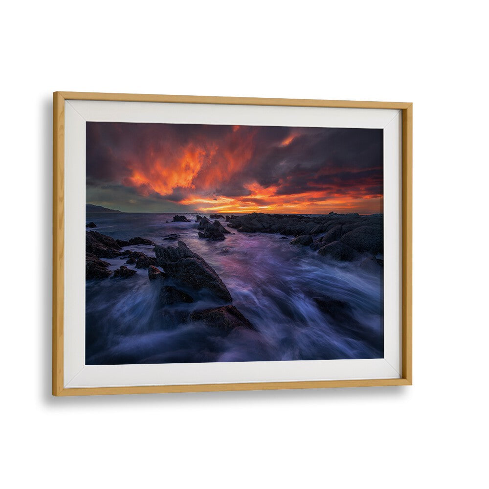 Transform your space with BURNING SKY, PHOTOGRAPHY PRINTS showcasing a stunning sunset over rocky coastlines.