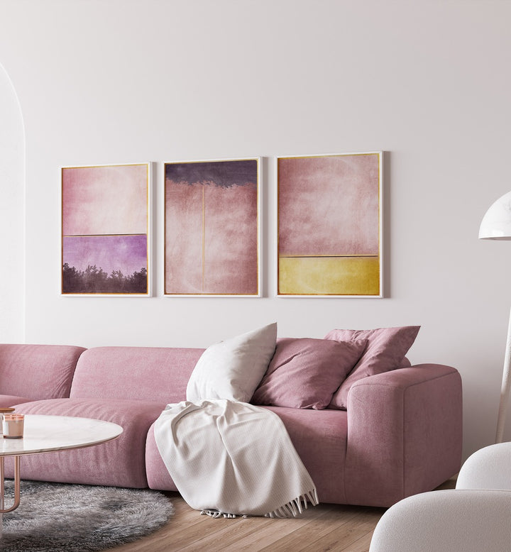 Elegant living room featuring the PLUM GOLD ABSTRACT SET, SET OF 3 PAINTINGS, enhancing sophistication and style.