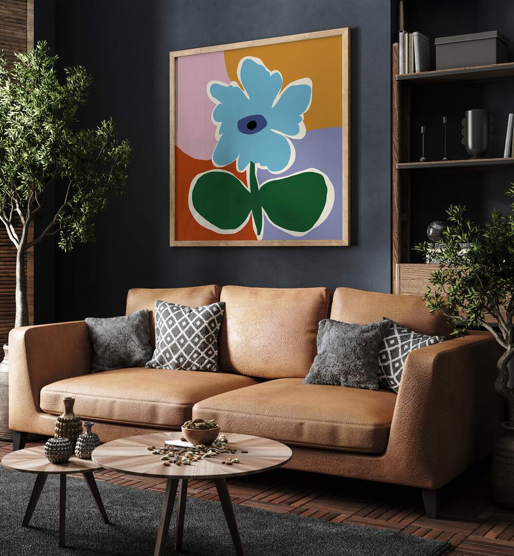 Retro Minimal Flower III, Botanical Art Paintings Artwork in Oak Wood Plain Frame placed on a Blue Colored Wall near a Brown Sofa in the Living Room